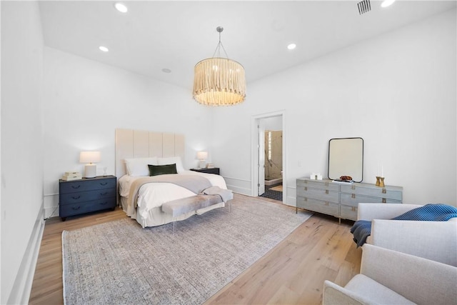 bedroom featuring recessed lighting, wood finished floors, visible vents, baseboards, and an inviting chandelier