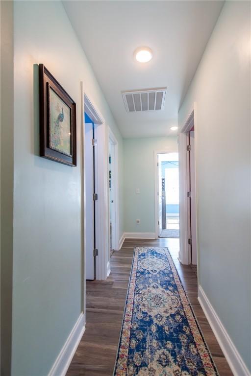 hall with dark hardwood / wood-style flooring