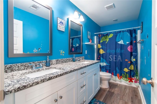 bathroom featuring toilet, walk in shower, hardwood / wood-style flooring, and vanity