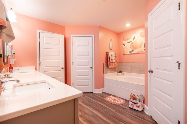 bathroom featuring vanity, a bathing tub, and hardwood / wood-style floors