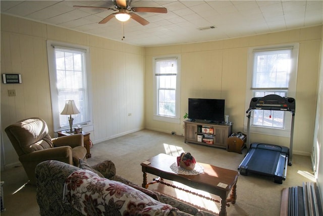 carpeted living room featuring ceiling fan