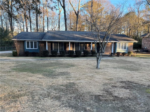 ranch-style home with a front lawn