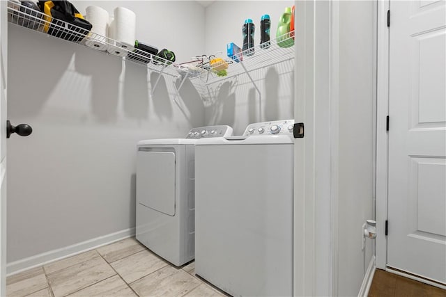 laundry room with independent washer and dryer and light tile patterned flooring