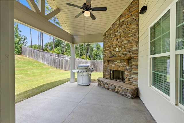 view of patio / terrace featuring an outdoor stone fireplace, area for grilling, and ceiling fan