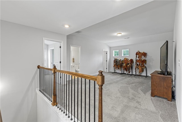 hallway featuring light carpet