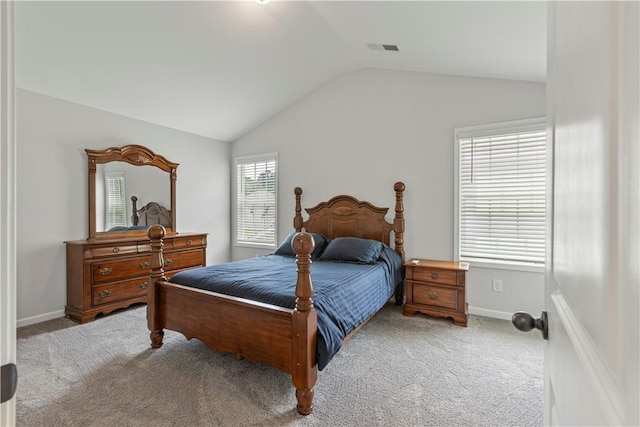 carpeted bedroom with vaulted ceiling