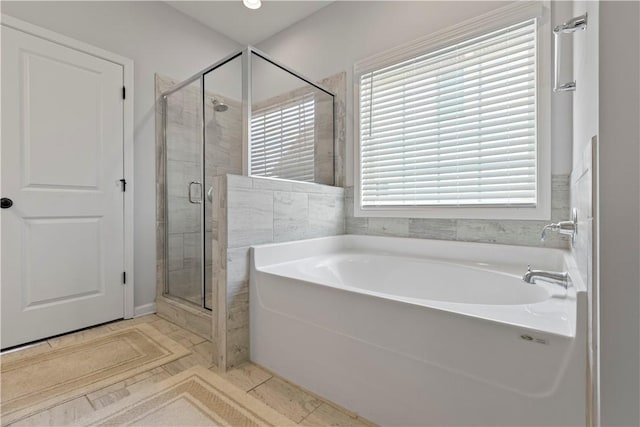 bathroom featuring separate shower and tub and tile patterned flooring