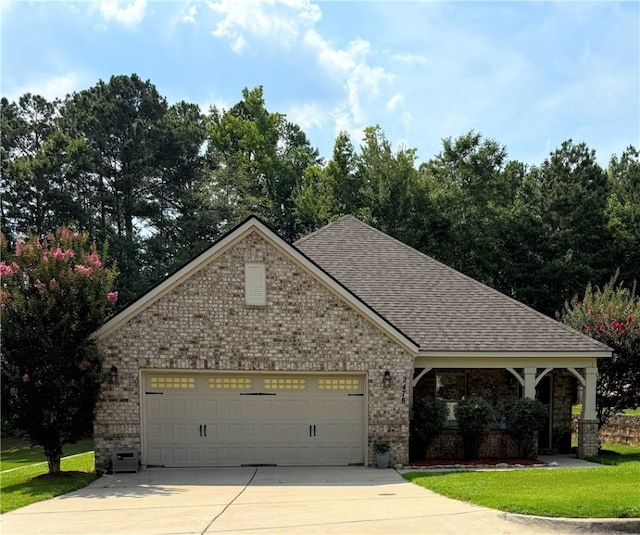 2476 Snowshill Ln, Auburn, AL 26832 - view of front of home featuring concrete driveway, a garage, brick siding, and a shingled roof