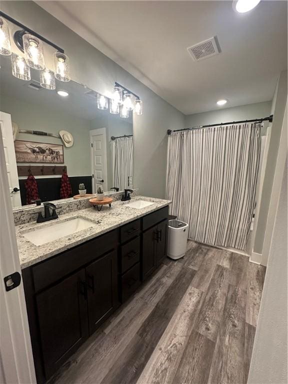 301 Lee Road 994, Cusseta, AL 36852 - full bath featuring wood finished floors, double vanity, a sink, and visible vents