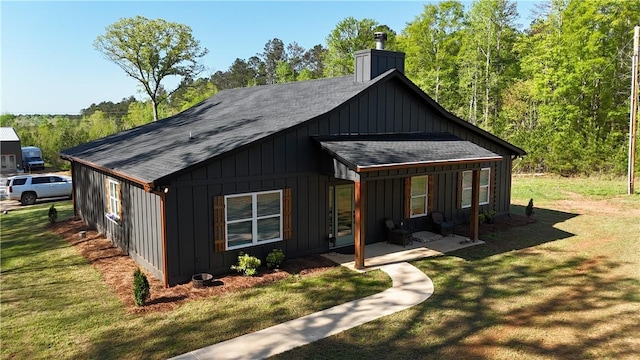 301 Lee Road 994, Cusseta, AL 36852 - exterior space with roof with shingles, board and batten siding, a front yard, and a chimney