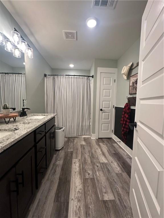 301 Lee Road 994, Cusseta, AL 36852 - bathroom featuring wood finished floors, double vanity, a sink, and visible vents