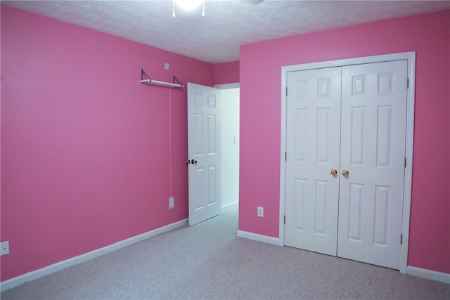 106 Pine Ridge Ln, Tallassee, AL 36078 - unfurnished bedroom featuring a textured ceiling, carpet floors, a closet, and ceiling fan