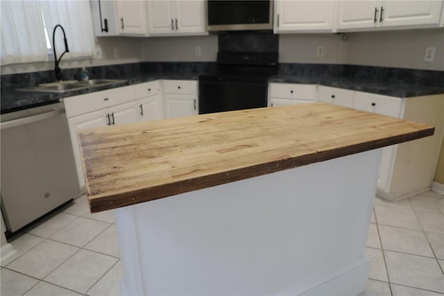 106 Pine Ridge Ln, Tallassee, AL 36078 - kitchen with dishwasher, range, light tile patterned floors, and butcher block counters