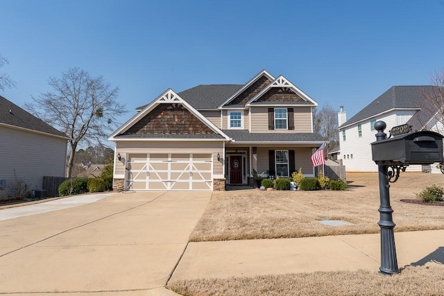 craftsman house with an attached garage, stone siding, driveway, and a shingled roof