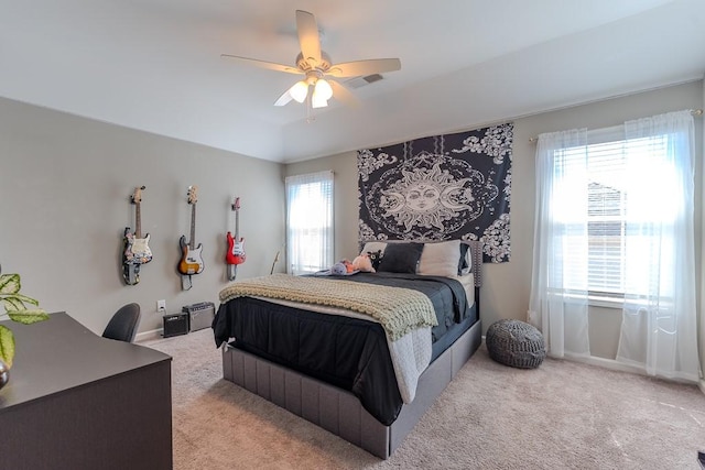 bedroom featuring ceiling fan, visible vents, and light colored carpet