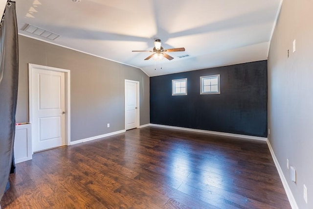 empty room with a ceiling fan, visible vents, baseboards, and wood finished floors