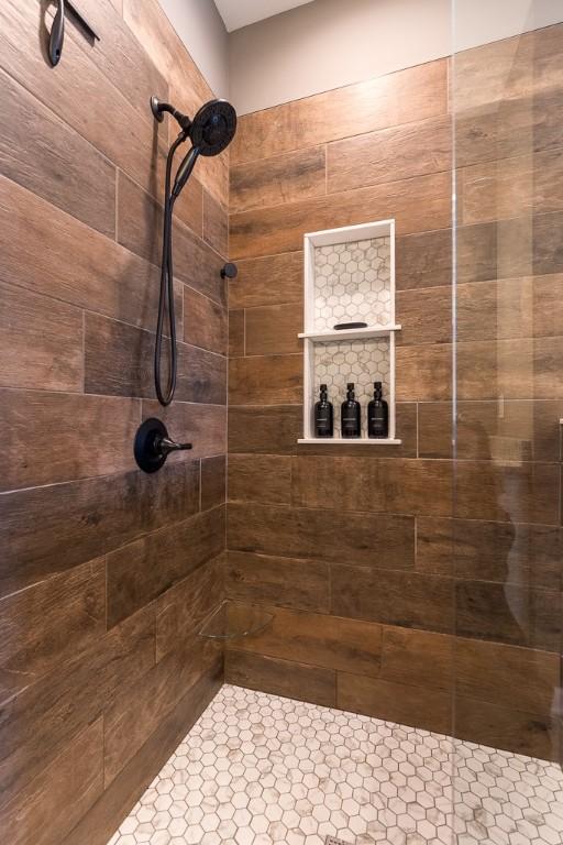 full bath with a tile shower