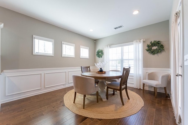 dining room with dark wood-style floors, recessed lighting, a wainscoted wall, and visible vents