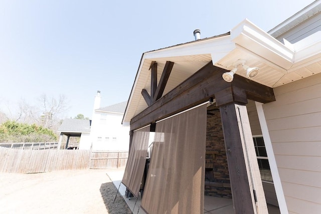 view of side of home with fence