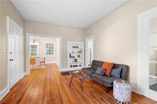 living room featuring light hardwood / wood-style floors and an inviting chandelier