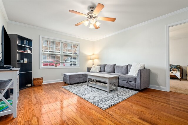 living room with wood finished floors, ornamental molding, and ceiling fan