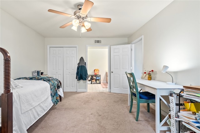 carpeted bedroom with a closet, visible vents, and ceiling fan