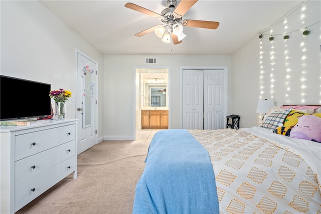 bedroom with visible vents, a ceiling fan, connected bathroom, baseboards, and light colored carpet