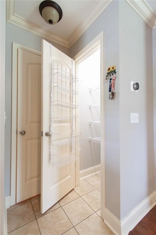 735 Hunter Ct, Auburn, AL 36832 - bathroom with ornamental molding, baseboards, and tile patterned flooring