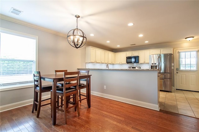 735 Hunter Ct, Auburn, AL 36832 - dining room with ornamental molding, a chandelier, light wood-type flooring, baseboards, and recessed lighting