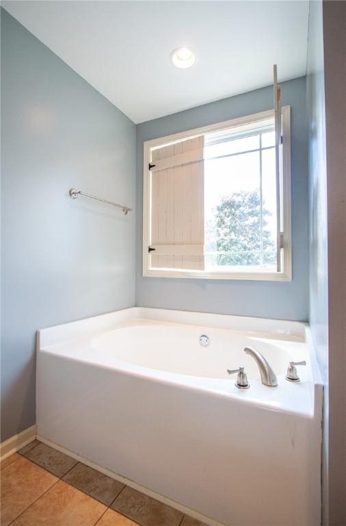 735 Hunter Ct, Auburn, AL 36832 - bathroom featuring a garden tub and tile patterned flooring