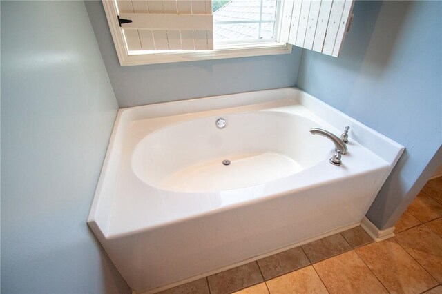 735 Hunter Ct, Auburn, AL 36832 - bathroom featuring a garden tub, tile patterned flooring, and baseboards