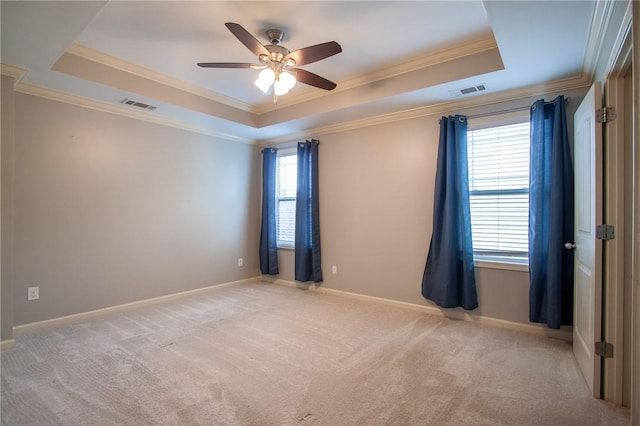 735 Hunter Ct, Auburn, AL 36832 - empty room featuring a raised ceiling, ornamental molding, a ceiling fan, light colored carpet, and baseboards