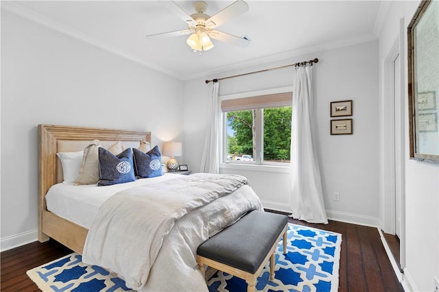 bedroom with ceiling fan, baseboards, wood finished floors, and ornamental molding