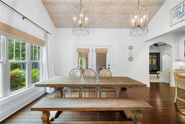 dining room with wood ceiling, arched walkways, dark wood-type flooring, and a notable chandelier