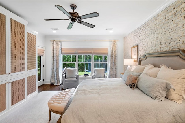 bedroom with wood finished floors, visible vents, and a ceiling fan