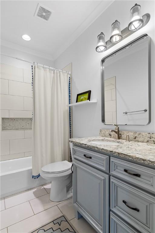 bathroom featuring visible vents, toilet, shower / bath combo with shower curtain, ornamental molding, and vanity