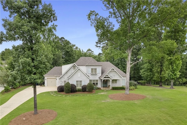 view of front of house featuring an attached garage, driveway, and a front yard