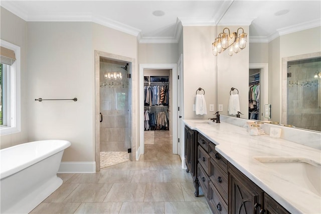 bathroom featuring double vanity, a stall shower, crown molding, and a soaking tub