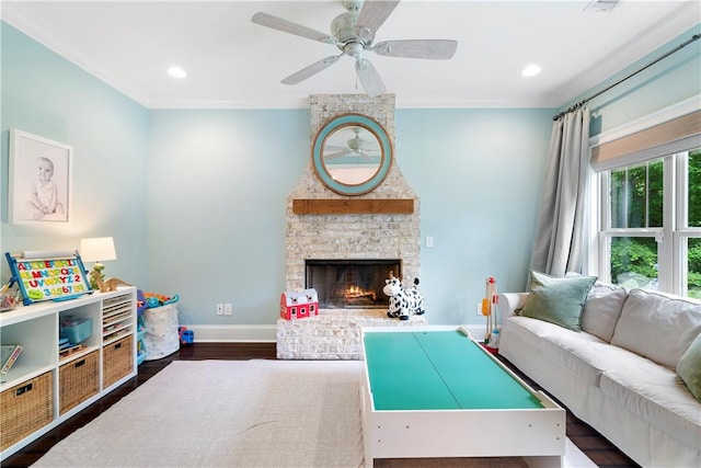 living area featuring dark wood-style floors, a fireplace, recessed lighting, ceiling fan, and baseboards