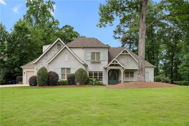 view of front of house with an attached garage and a front yard