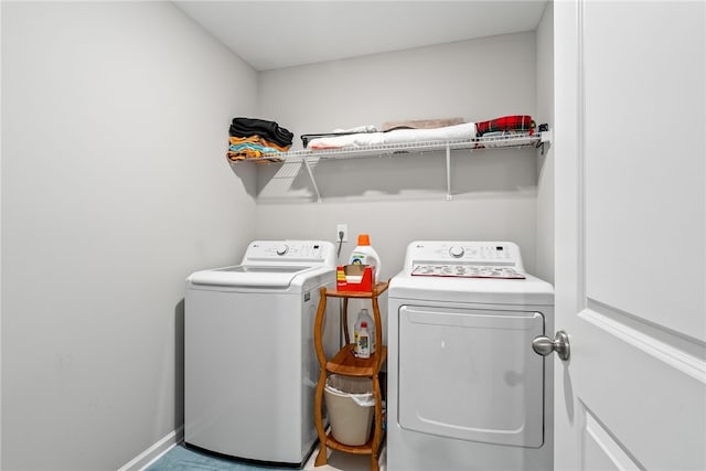 laundry room featuring laundry area, washer and clothes dryer, and baseboards