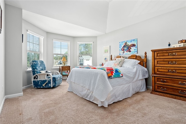 carpeted bedroom featuring baseboards