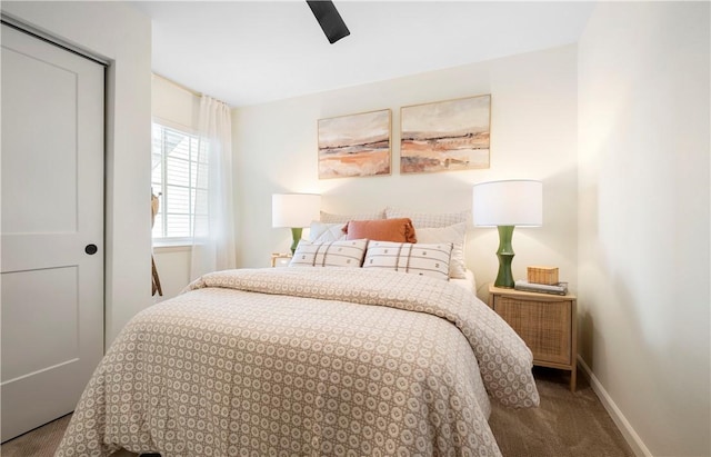 carpeted bedroom featuring baseboards and ceiling fan