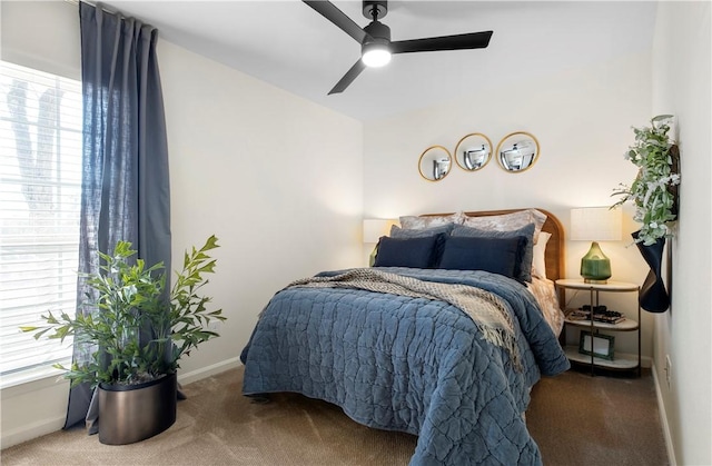 carpeted bedroom featuring ceiling fan and baseboards