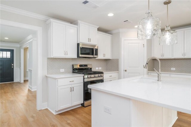 2022 Hidden Lakes Dr, Opelika, AL 36801 - kitchen with appliances with stainless steel finishes, a sink, crown molding, light countertops, and tasteful backsplash