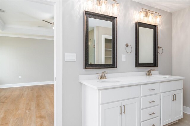 2022 Hidden Lakes Dr, Opelika, AL 36801 - bathroom featuring wood finished floors, double vanity, a ceiling fan, and baseboards