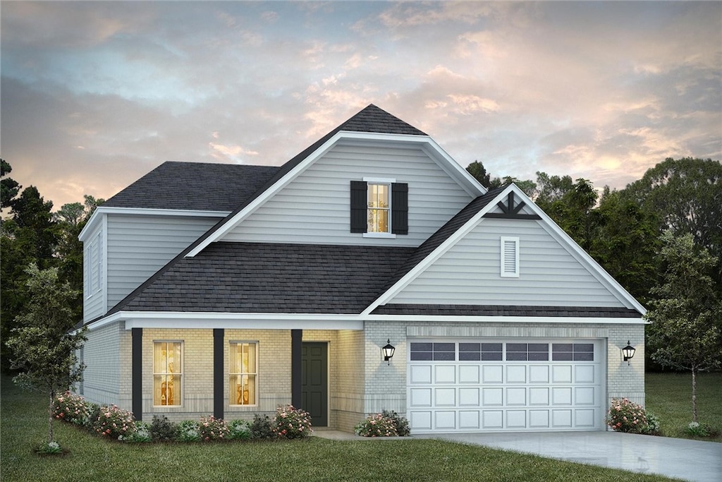 view of front of house with a yard and a garage