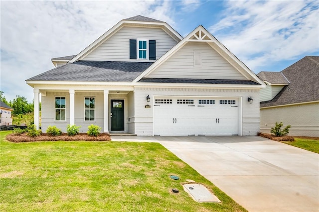 2022 Hidden Lakes Dr, Opelika, AL 36801 - view of front of home featuring a front lawn, concrete driveway, a shingled roof, brick siding, and a garage
