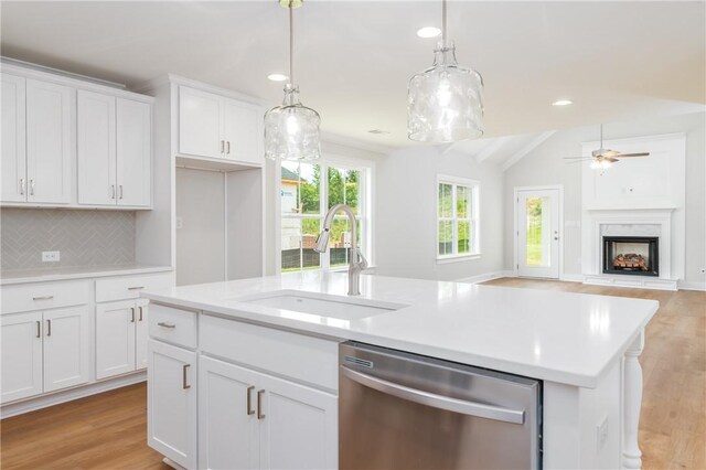 2022 Hidden Lakes Dr, Opelika, AL 36801 - kitchen with dishwasher, a sink, an island with sink, light wood-style flooring, and lofted ceiling