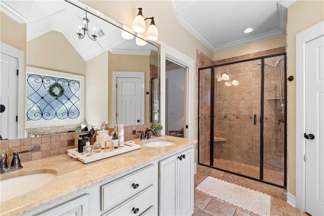 bathroom featuring vaulted ceiling, ornamental molding, vanity, and a shower with shower door